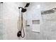 Close up of bathroom shower with marbled wall tiles, modern shower head and fixtures at 2742 Oakland Ter, Decatur, GA 30032