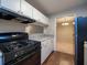 Kitchen with stainless steel appliances, white cabinets, and wood-look flooring at 408 Smokerise Se Cir, Marietta, GA 30067