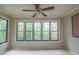 Sunroom with natural light entering through a bank of windows overlooking mature trees at 408 Smokerise Se Cir, Marietta, GA 30067