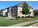 Well-maintained backyard with lush green grass, mature trees, and an expansive patio at 4405 Croftshire Pl, Cumming, GA 30040