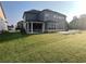 Expansive backyard featuring a well-maintained lawn and covered porch, perfect for outdoor activities and relaxation at 4405 Croftshire Pl, Cumming, GA 30040