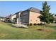 View of the lawn in the backyard of this home with neutral siding and a hardscaped patio at 4405 Croftshire Pl, Cumming, GA 30040