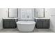 Bright bathroom featuring double sinks and a stand alone tub at 4405 Croftshire Pl, Cumming, GA 30040