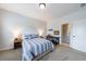 Bedroom featuring plush carpet, two windows, desk area, and ensuite bathroom beyond an open door at 4405 Croftshire Pl, Cumming, GA 30040