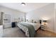 Bedroom with plush carpet, large windows, and neutral decor. The room features a built in desk area at 4405 Croftshire Pl, Cumming, GA 30040