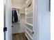 Well-organized walk-in closet featuring built-in shelving and hanging rods, perfect for storage at 4405 Croftshire Pl, Cumming, GA 30040