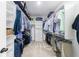 Walk-in closet with custom white shelving, hanging racks, and carpet flooring at 4405 Croftshire Pl, Cumming, GA 30040