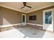 Relaxing covered patio with ceiling fan, mounted TV, and brick accents at 4405 Croftshire Pl, Cumming, GA 30040