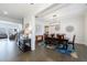 Open-concept dining room featuring hardwood floors and elegant decor adjacent to the living room at 4405 Croftshire Pl, Cumming, GA 30040