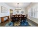 Elegant dining room showcasing hardwood floors, modern lighting, and a decorative rug at 4405 Croftshire Pl, Cumming, GA 30040