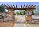 Stone community entrance featuring a walkway beneath a timber trellis at 4405 Croftshire Pl, Cumming, GA 30040