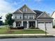 Charming brick home with three-car garage and covered porch in established neighborhood at 4405 Croftshire Pl, Cumming, GA 30040