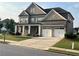 Beautiful two-story brick home featuring an attached two car garage, landscaped front yard and covered front porch at 4405 Croftshire Pl, Cumming, GA 30040
