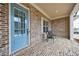 Inviting front porch with a stylish blue door, brick accents, and a seating area at 4405 Croftshire Pl, Cumming, GA 30040