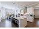 Open-concept kitchen with a large island, stainless steel appliances, and views of the dining area at 4405 Croftshire Pl, Cumming, GA 30040