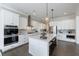 Bright modern kitchen with an island, white cabinets, stainless steel appliances, and lots of storage at 4405 Croftshire Pl, Cumming, GA 30040