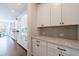 Kitchen pantry with marble countertops and white cabinetry, offering ample storage space at 4405 Croftshire Pl, Cumming, GA 30040