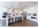 Well-lit kitchen featuring a large island, stainless steel appliances, and custom white cabinets at 4405 Croftshire Pl, Cumming, GA 30040