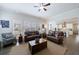 Spacious living room featuring hardwood floors, comfortable leather sofas, and large windows at 4405 Croftshire Pl, Cumming, GA 30040