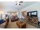 A comfortable living room featuring hardwood floors, modern TV, and a view of the kitchen at 4405 Croftshire Pl, Cumming, GA 30040