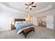 Relaxing main bedroom with tray ceiling, ceiling fan, chair, and decorative rug at 4405 Croftshire Pl, Cumming, GA 30040