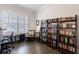 Bright home office with hardwood floors, built-in bookshelves, and a comfortable seating area at 4405 Croftshire Pl, Cumming, GA 30040