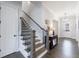 Elegant staircase featuring hardwood steps, iron railings, and modern lighting at 4405 Croftshire Pl, Cumming, GA 30040