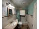 Bathroom with a sink, mirror, toilet, and a bathtub with a shower curtain at 675 Sowell Rd, Mcdonough, GA 30252