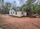 Charming home featuring vinyl siding, a cozy deck, and a spacious yard surrounded by lush greenery at 675 Sowell Rd, Mcdonough, GA 30252