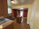 Cozy kitchen with appliances and a tile floor, featuring an island and wood cabinets at 675 Sowell Rd, Mcdonough, GA 30252