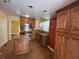 A functional kitchen featuring tile floors, stainless appliances, and wooden cabinetry at 675 Sowell Rd, Mcdonough, GA 30252