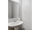 Bathroom with pedestal sink, clean white walls and modern finishes at 7937 Habanera Ln, Lithonia, GA 30058