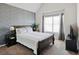 Cozy bedroom showcases a textured accent wall, window and a comfortable bed at 7937 Habanera Ln, Lithonia, GA 30058