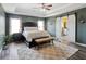 Comfortable primary bedroom with a sliding barn door to the en suite bathroom at 7937 Habanera Ln, Lithonia, GA 30058