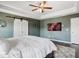 Bright bedroom with tray ceilings, barn door, and a ceiling fan at 7937 Habanera Ln, Lithonia, GA 30058