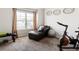 A bonus room with an exercise bike, lounger and decorative wall pieces at 7937 Habanera Ln, Lithonia, GA 30058