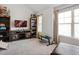 Bonus room features a TV, shelving units and workout bench at 7937 Habanera Ln, Lithonia, GA 30058