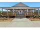 Charming clubhouse with covered entrance, wooden deck, and welcoming access ramp at 7937 Habanera Ln, Lithonia, GA 30058