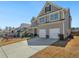 Traditional-style home with a large driveway and a two-car garage at 7937 Habanera Ln, Lithonia, GA 30058