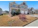Two-story home features a well-maintained front yard and attached two-car garage at 7937 Habanera Ln, Lithonia, GA 30058