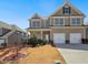 Inviting two-story home with manicured lawn and classic architectural details at 7937 Habanera Ln, Lithonia, GA 30058