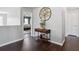 Elegant foyer with hardwood floors, decorative table, and a view into the Primary bedroom at 7937 Habanera Ln, Lithonia, GA 30058
