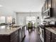 Gourmet kitchen featuring a center island, stainless appliances, and ample lighting at 7937 Habanera Ln, Lithonia, GA 30058