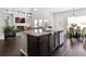 Bright, open kitchen with granite counters, island, and hardwood floors at 7937 Habanera Ln, Lithonia, GA 30058