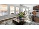 Cozy living room featuring large windows, a comfortable couch and a decorative rug at 7937 Habanera Ln, Lithonia, GA 30058