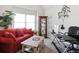 Bright living room setup with a red couch, coffee table, desk and decor at 7937 Habanera Ln, Lithonia, GA 30058