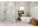 Modern bathroom featuring freestanding tub, glass enclosed shower, and marble tile at 1304 Marietta Country Club Nw Dr, Kennesaw, GA 30152