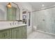 Modern bathroom featuring a marble countertop, stylish vanity and large glass-enclosed shower at 1304 Marietta Country Club Nw Dr, Kennesaw, GA 30152