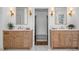 Double vanity bathroom featuring wood cabinets, marble countertop, and attractive lighting fixtures at 1304 Marietta Country Club Nw Dr, Kennesaw, GA 30152