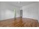 Bedroom with hardwood floors, closet and bright lighting, offering a cozy and modern retreat at 1304 Marietta Country Club Nw Dr, Kennesaw, GA 30152